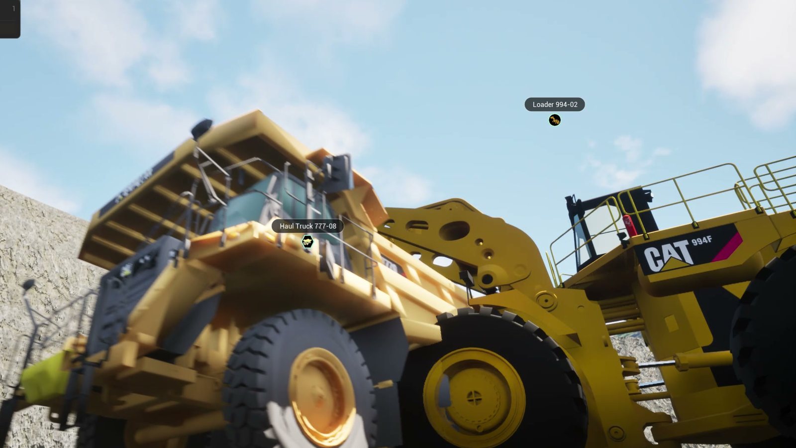 Wheel loader filling a haul truck on the MineZero sandbox site, with telemetry-driven bucket and tray motion